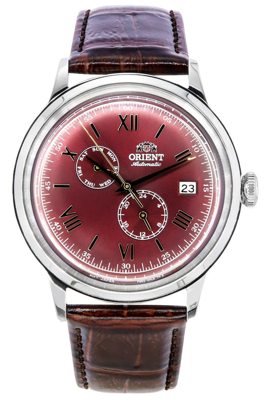 Orient Bambino GMT Version 8 Leather Strap Red Dial. A brand-new Orient Bambino watch featuring a Red dial and a Leather strap. Side view.